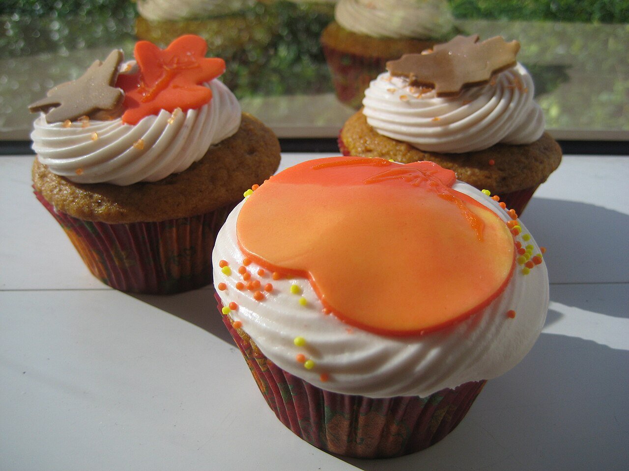 Adding candy eyes and beak to turkey cupcake faces