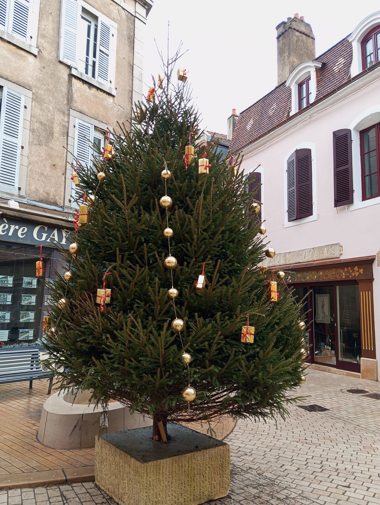 Burgundy christmas tree decor ideas with a velvet tree skirt grounding the display
