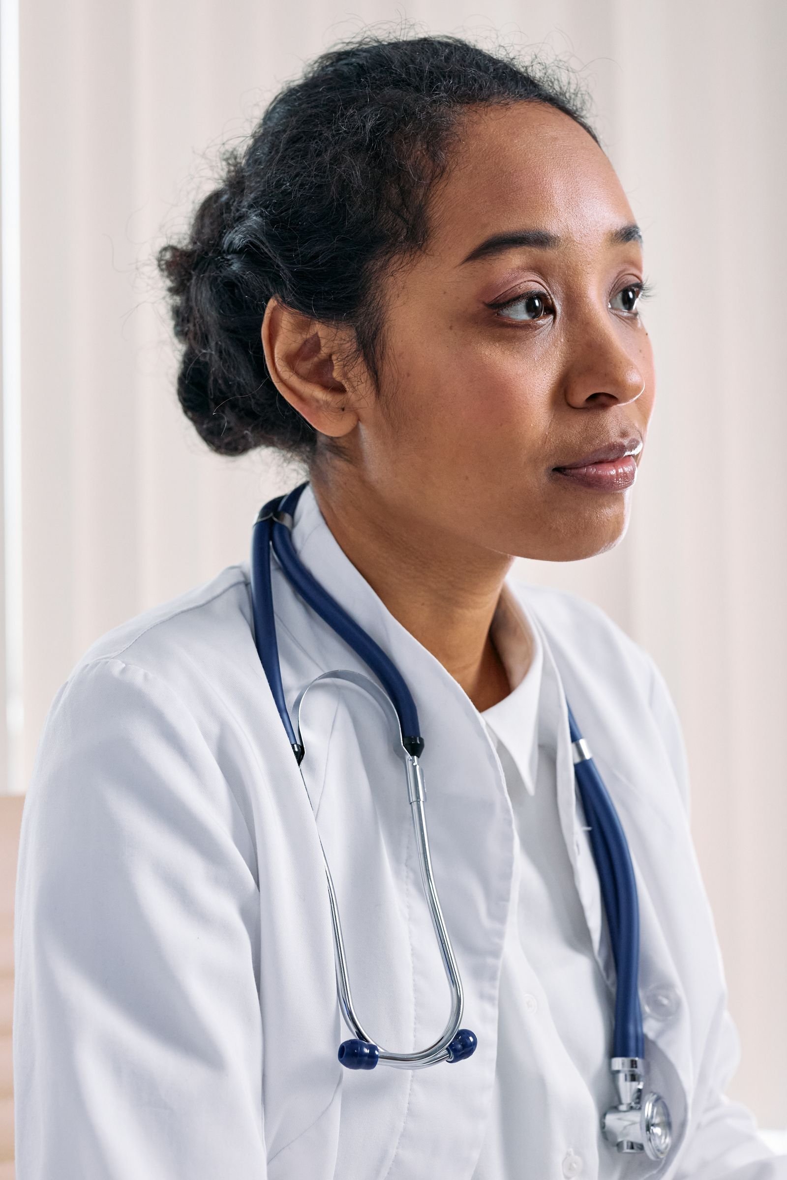 Female doctor-inspired smart look with belted cape coat