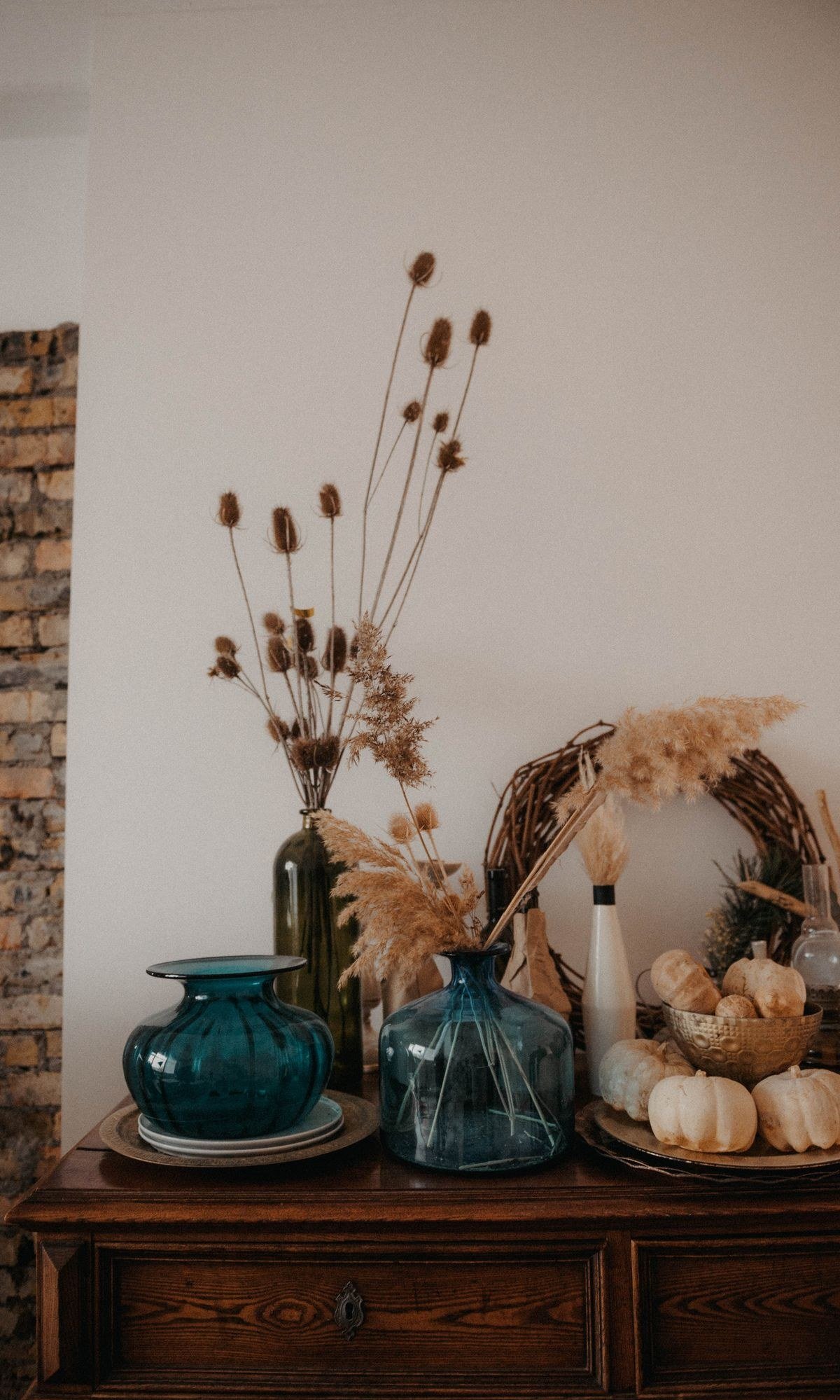 Warm table lamp glowing in minimalist fall decorated room at dusk