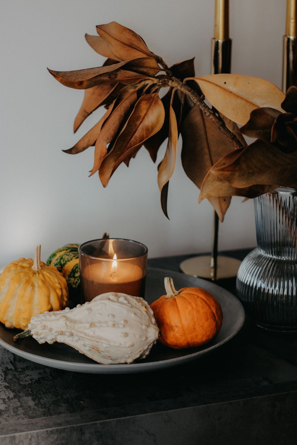 Cluttered versus clean fall decor comparison showing minimalist styling