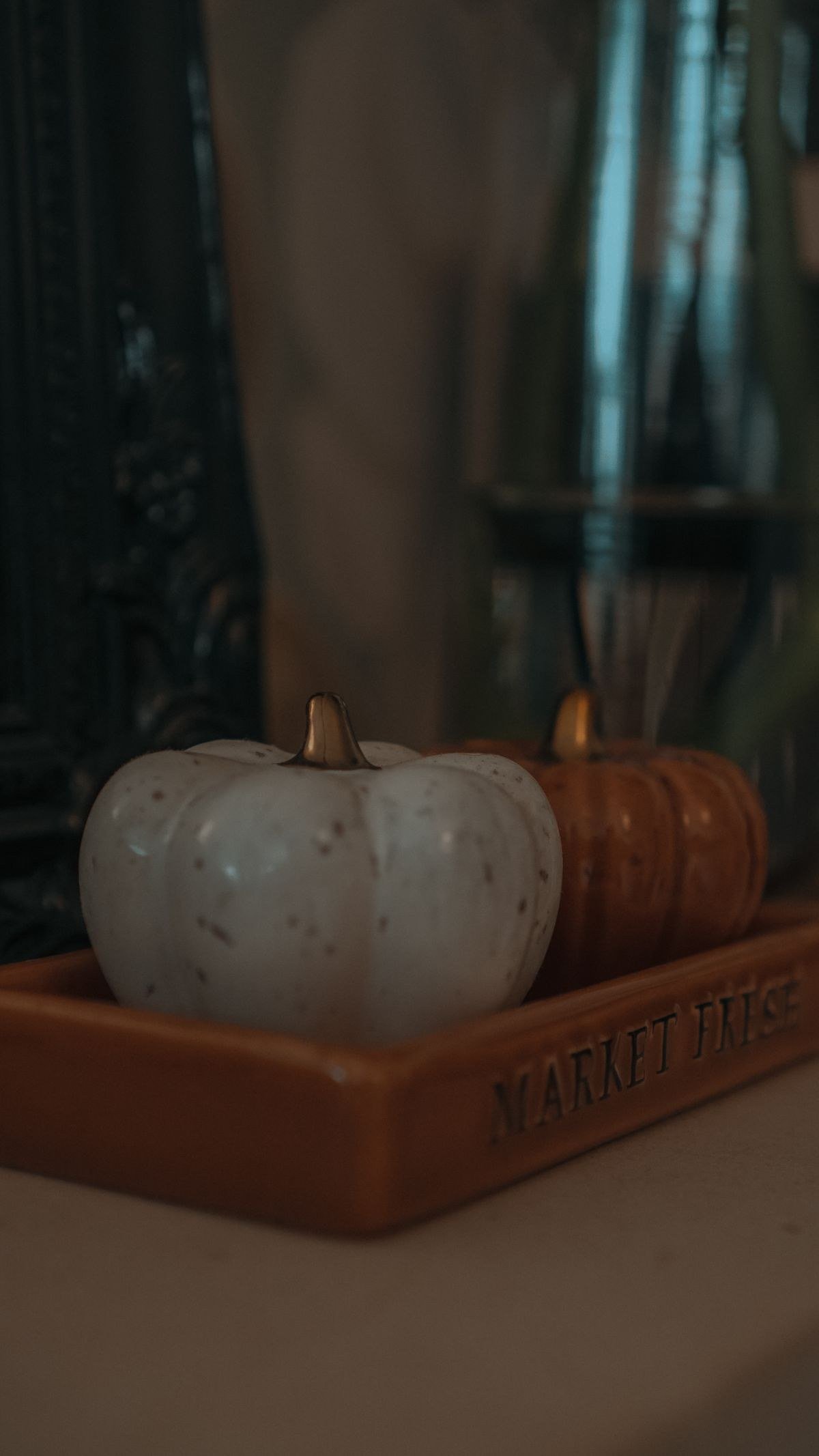 Warm minimalist fall decor vignette with candle tray and dried stems
