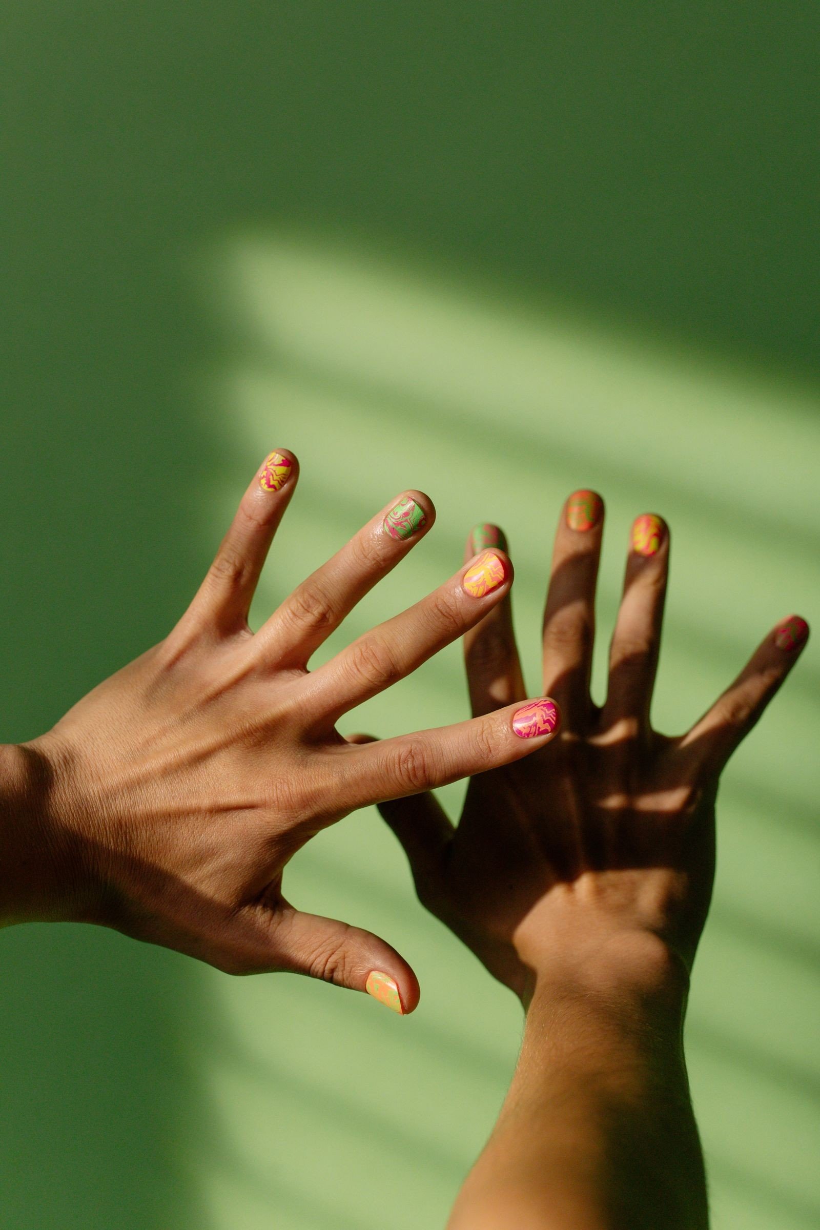 Nail polish bottles in complementary colours side by side