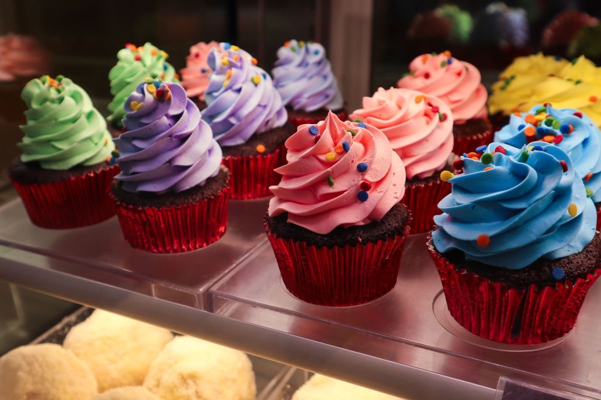 Freshly baked vanilla cupcakes cooling on a wire rack