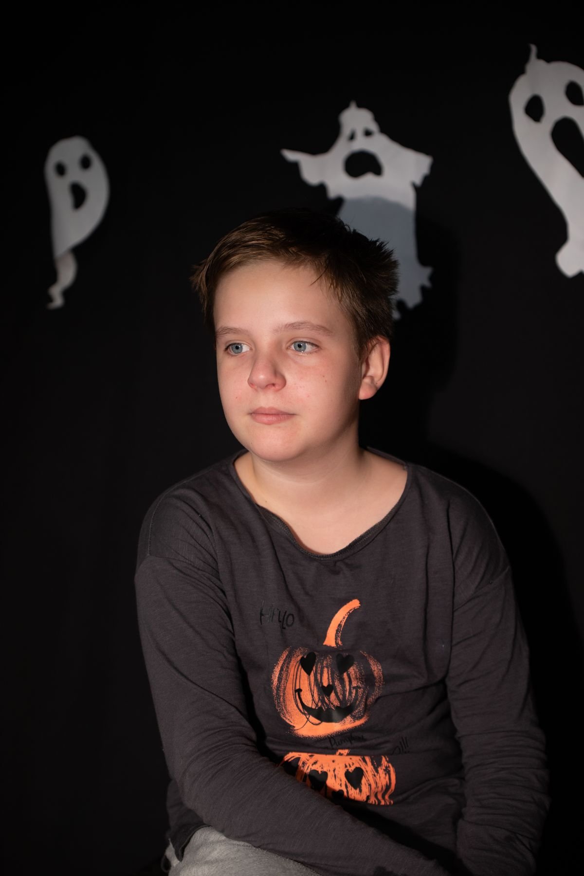 Kids decorating their own ghost cupcakes at a Halloween party
