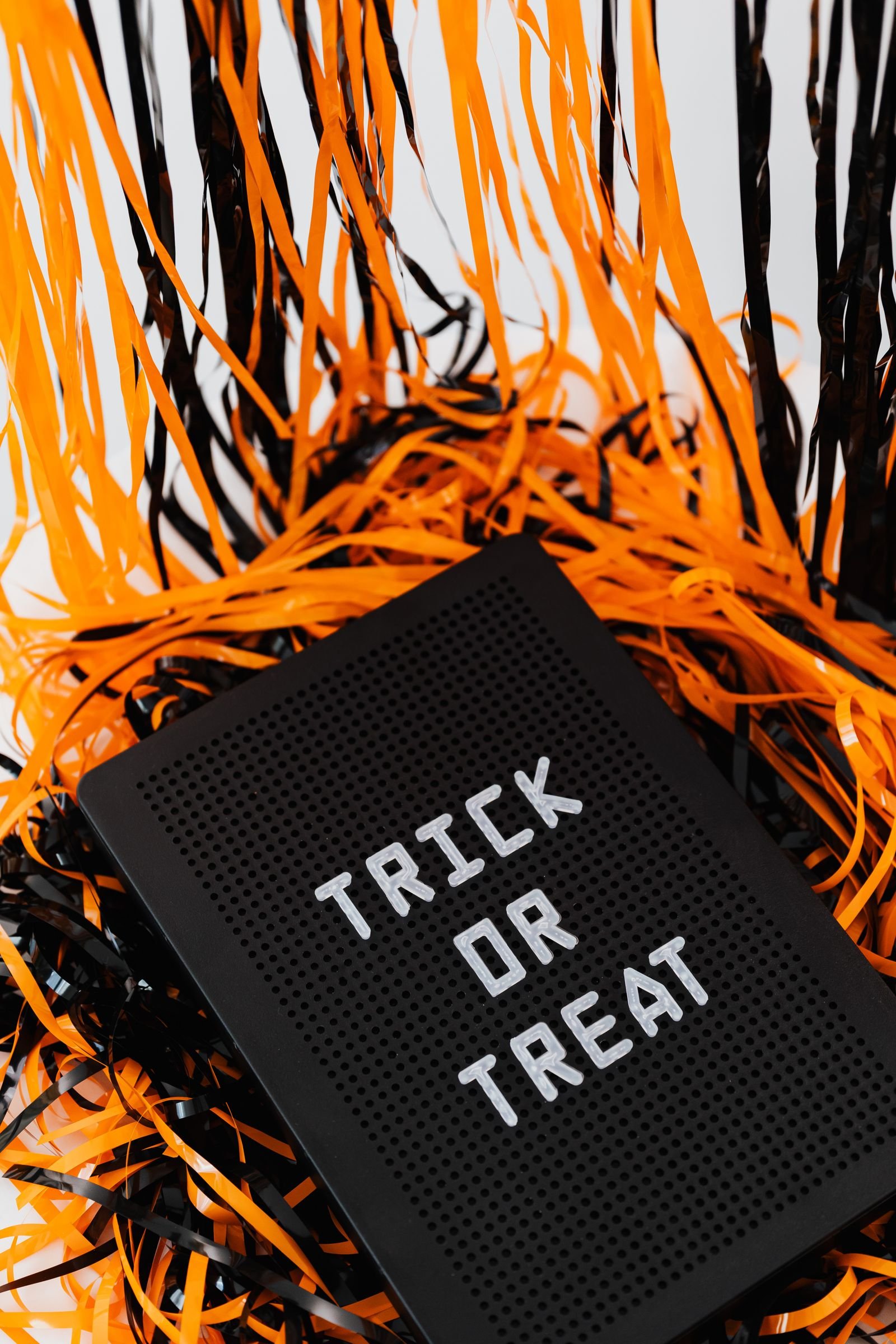 White handprint ghost garland with drawn faces hanging at a Halloween party