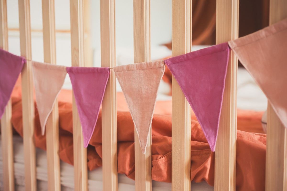 Soft striped crib bedding and cozy rug in circus nursery