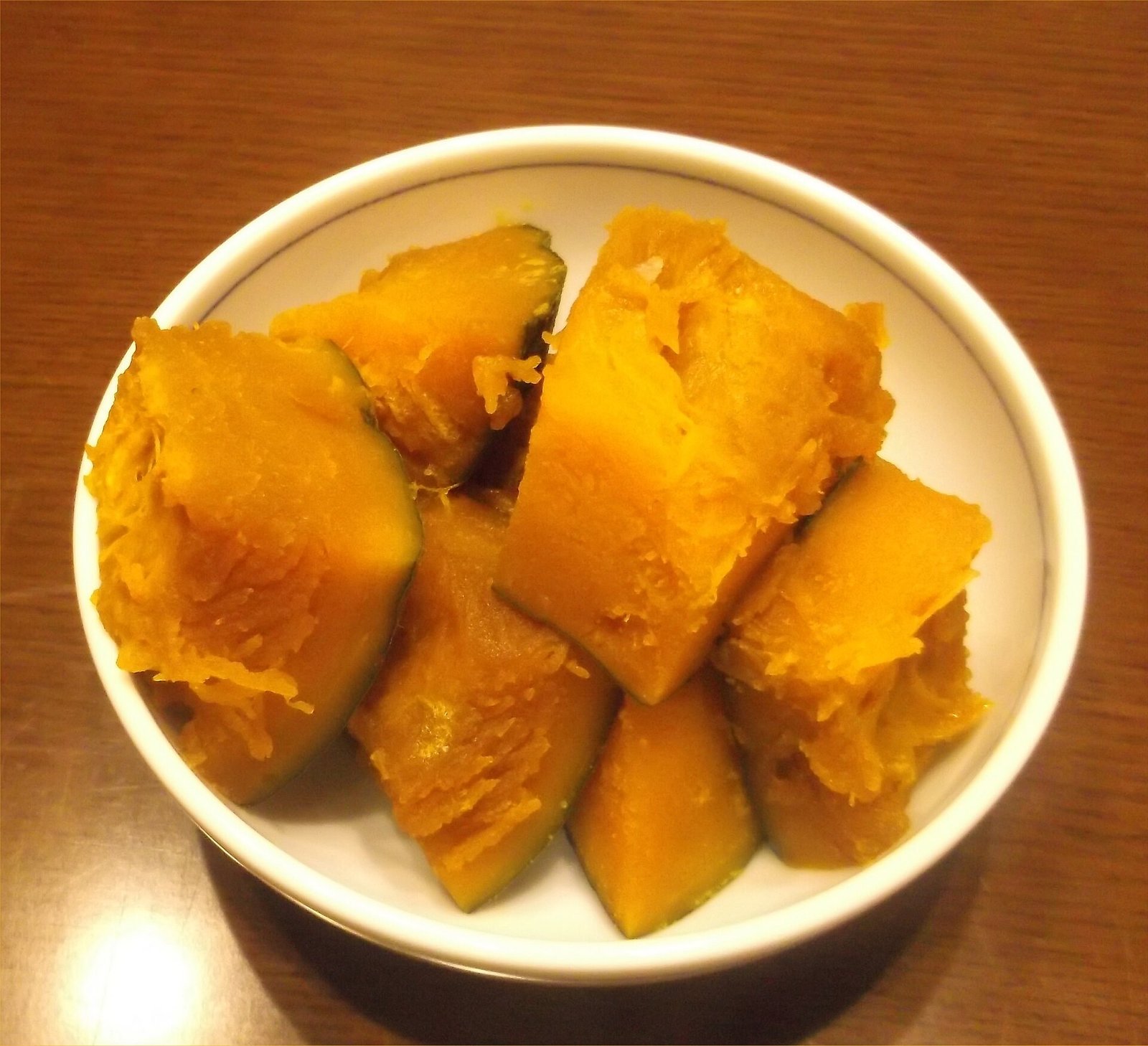 Pumpkin curry soup simmering gently in a large pot on the stove