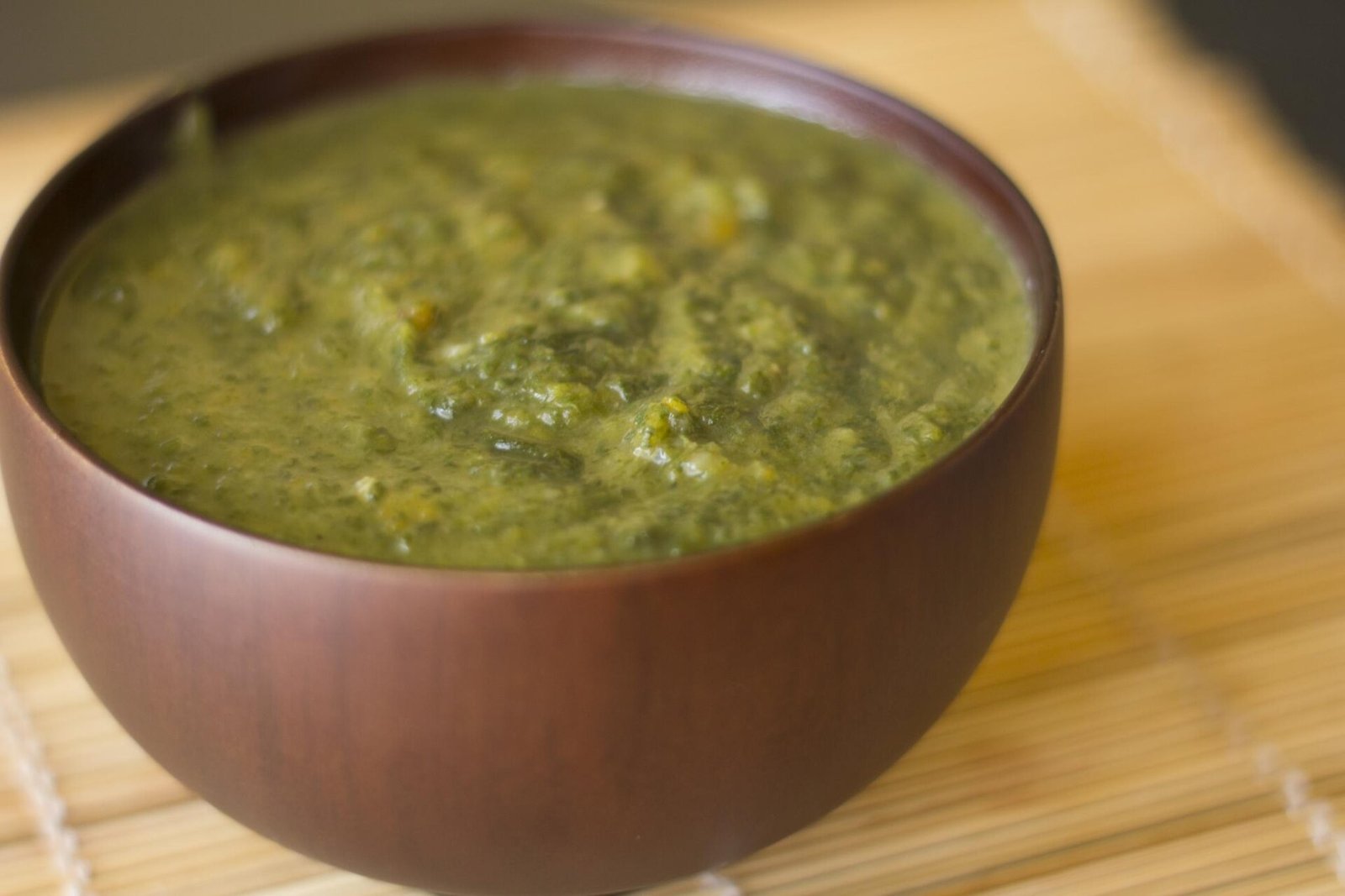 Blending pumpkin curry soup smooth with a stick blender in the pot