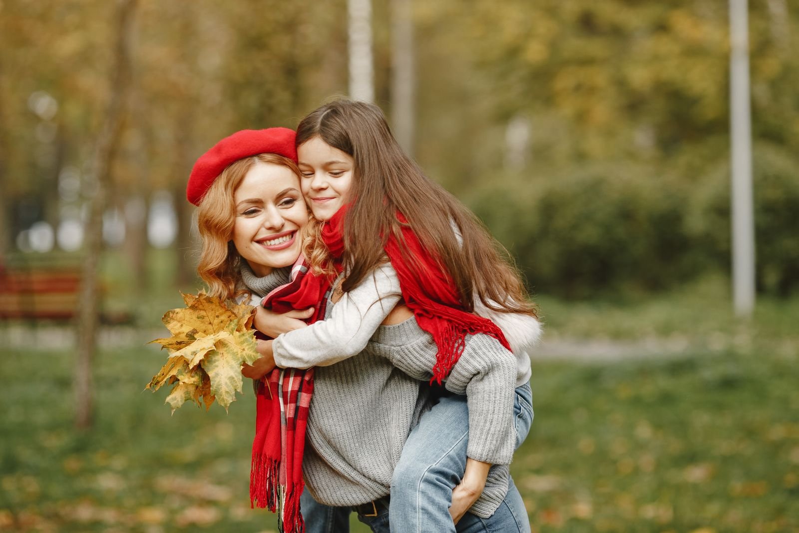 Loving moment between mother and daughter on a beautiful fall day in the park