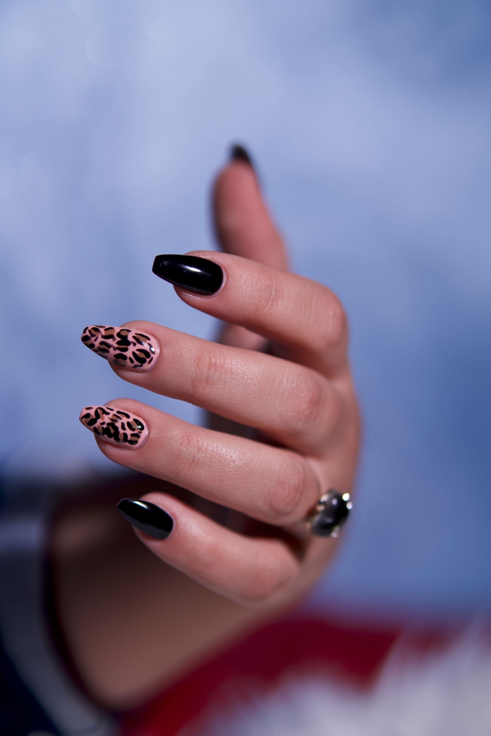 Close-up of black cat eye nail design with dimensional magnetic stripe