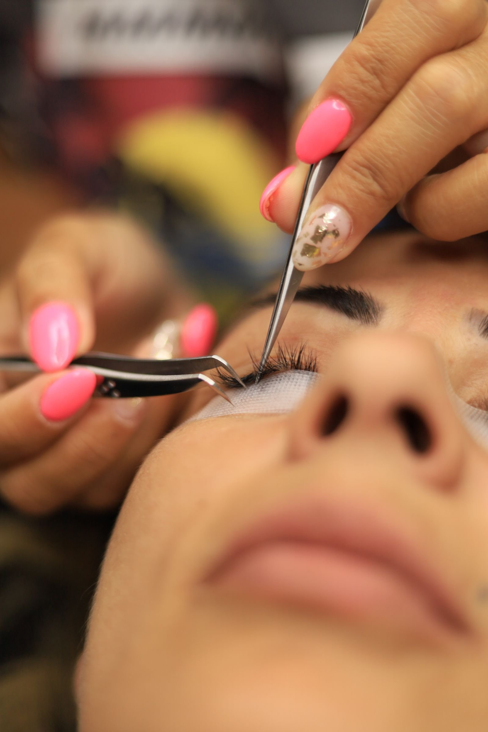Dramatic eye makeup look paired with dark cat eye manicured nails