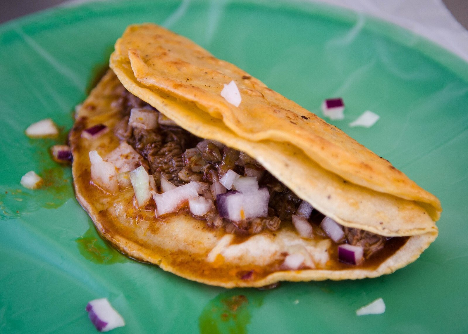 Birria tacos recipe with crispy beef birria tacos and a cup of rich consommé for dipping