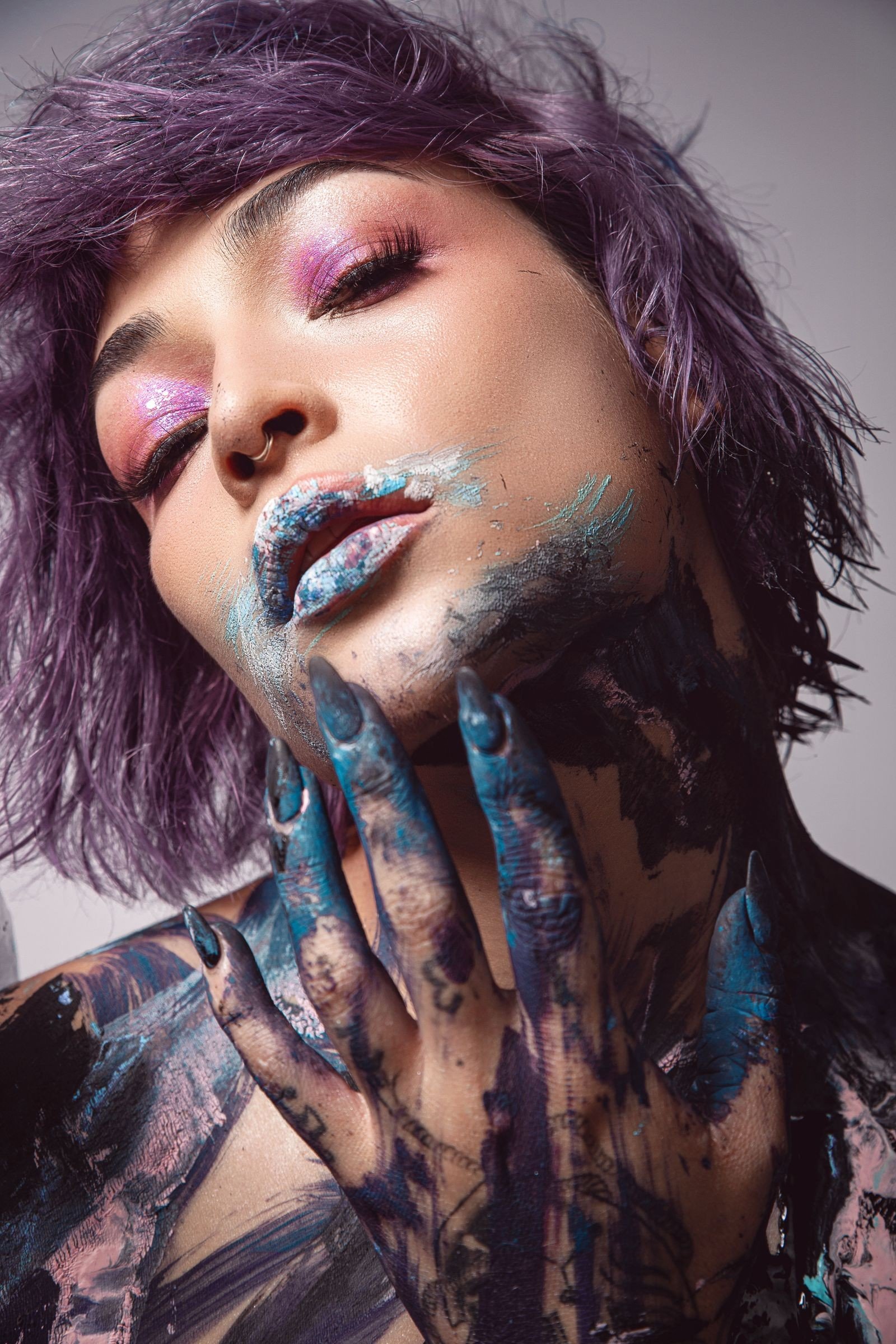 Face gems and glitter accenting an eccentric makeup look
