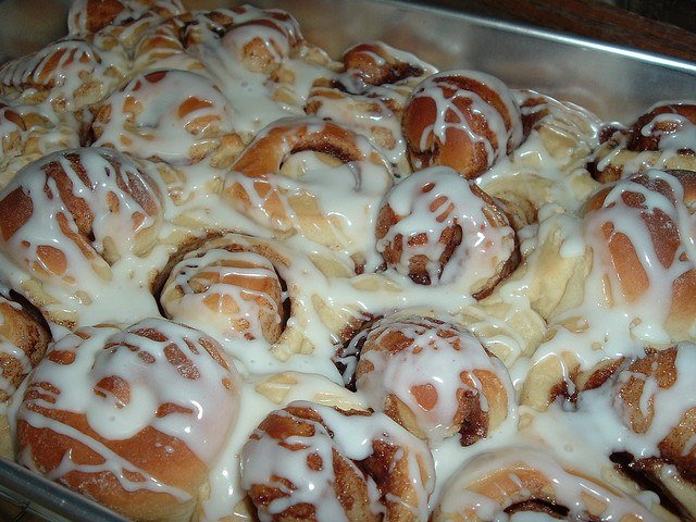 Kneading soft cinnamon roll dough on a floured surface by hand