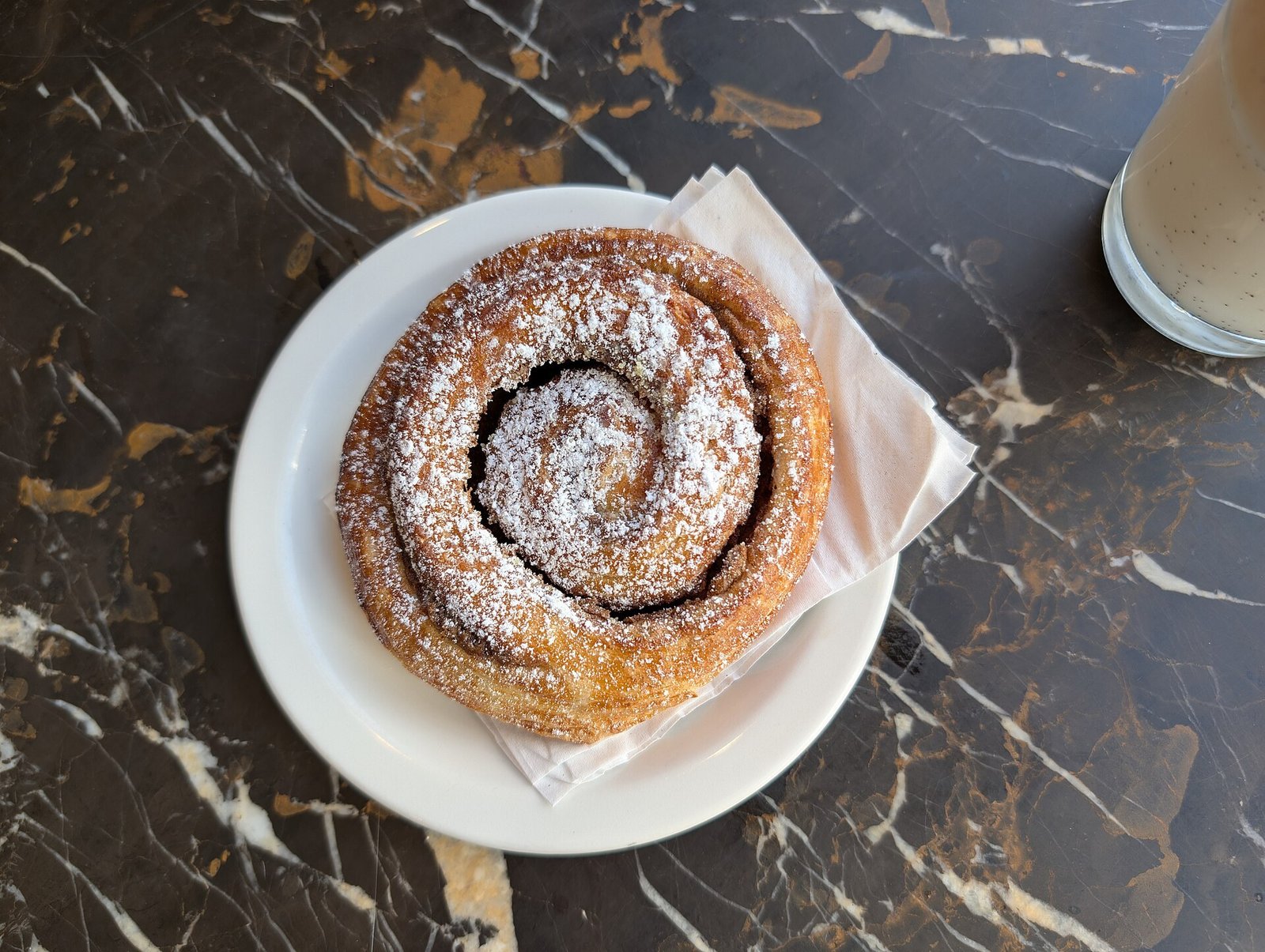 Cinnamon roll dough risen and doubled in size in an oiled bowl