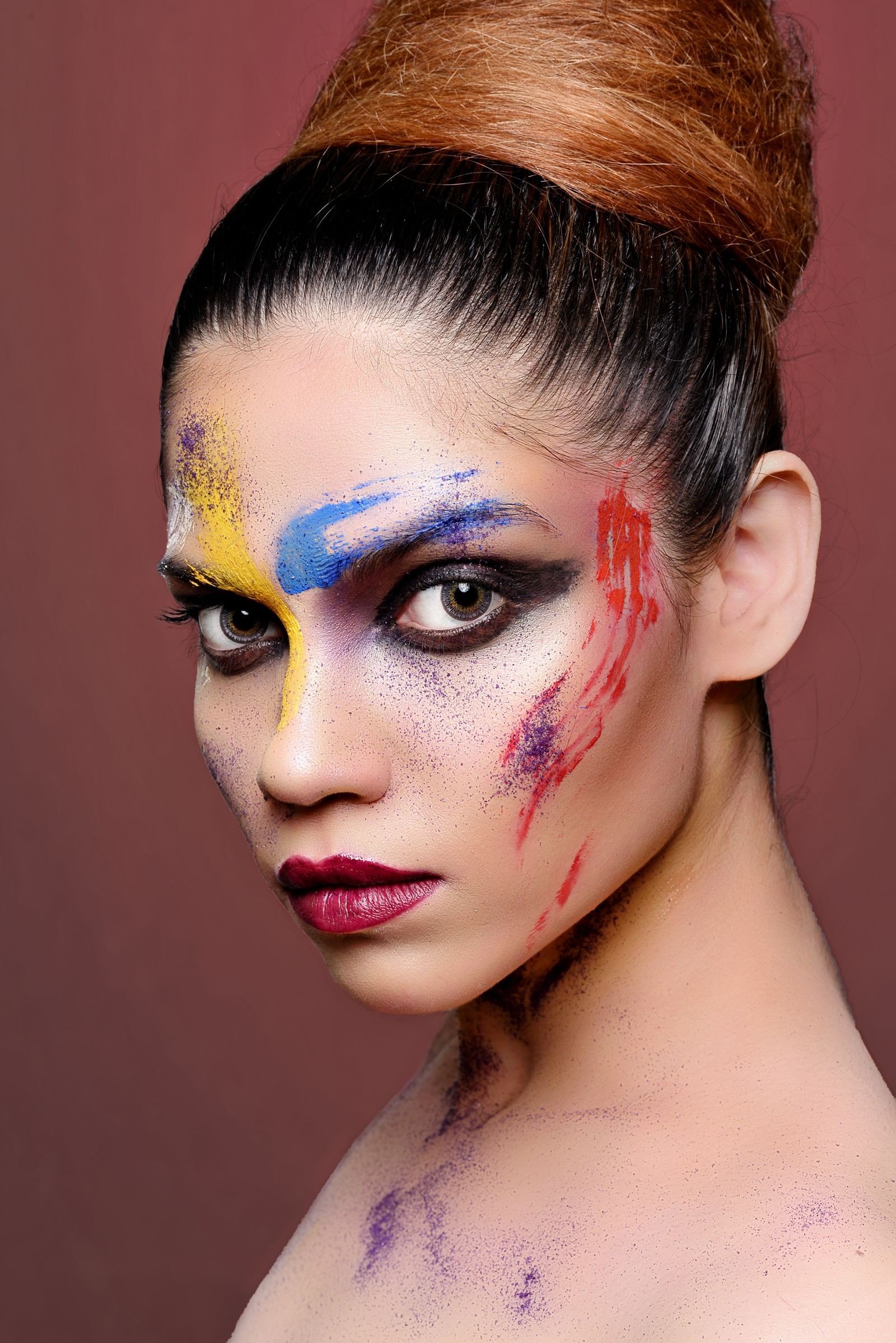 Abstract artistic face makeup with swirls and dots