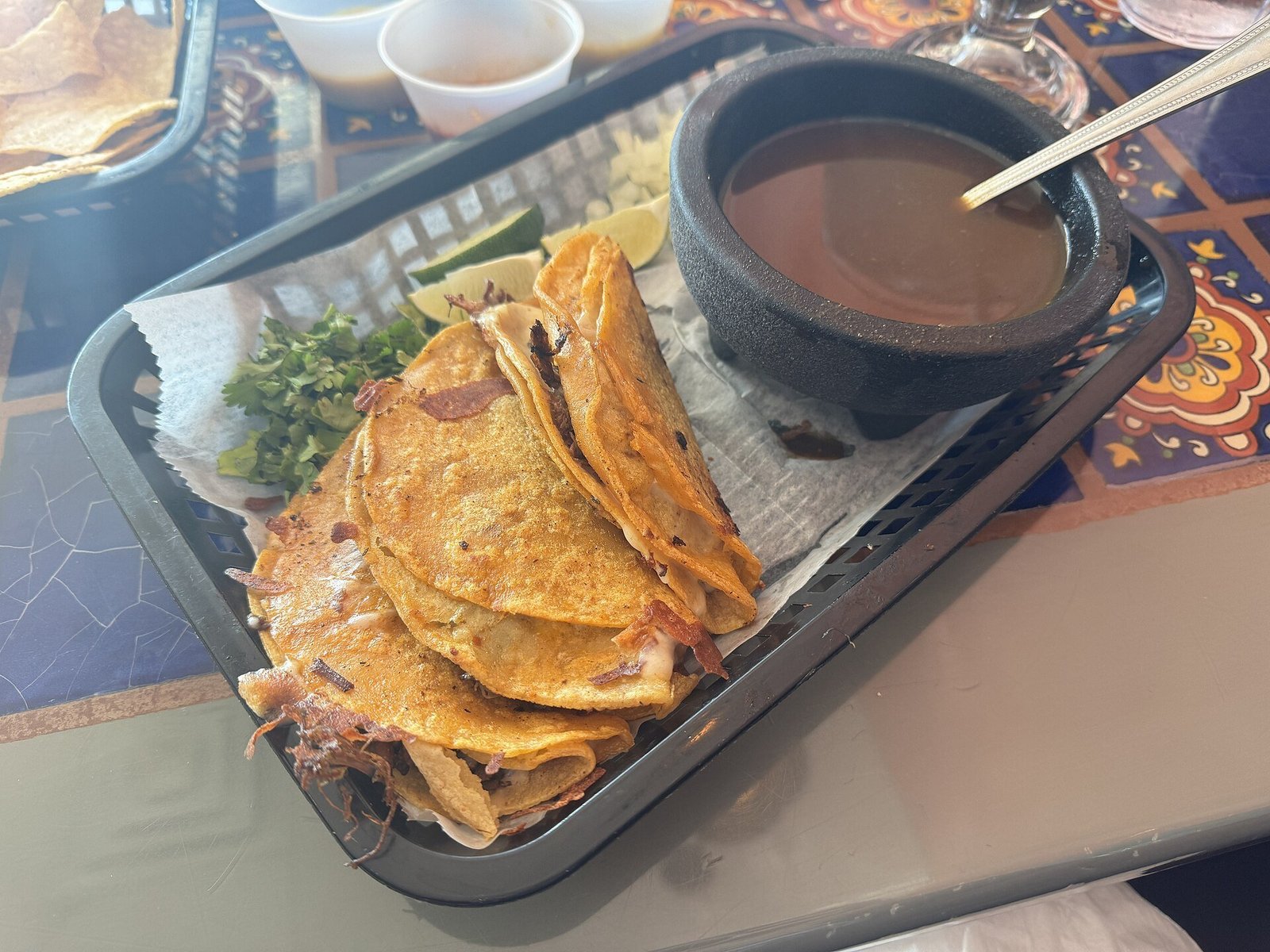 Birria tacos recipe shredding tender braised beef with two forks