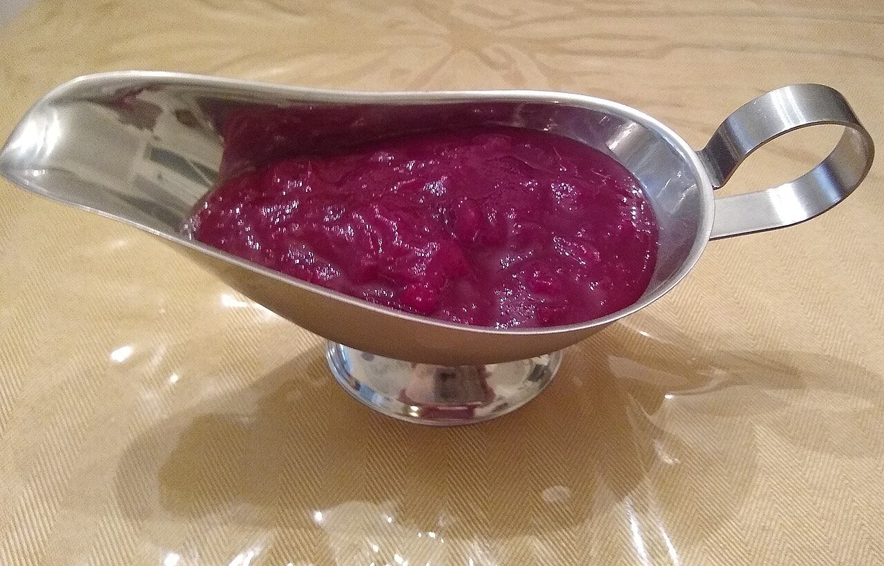 Cranberry sauce ready to serve alongside festive drinks for guests