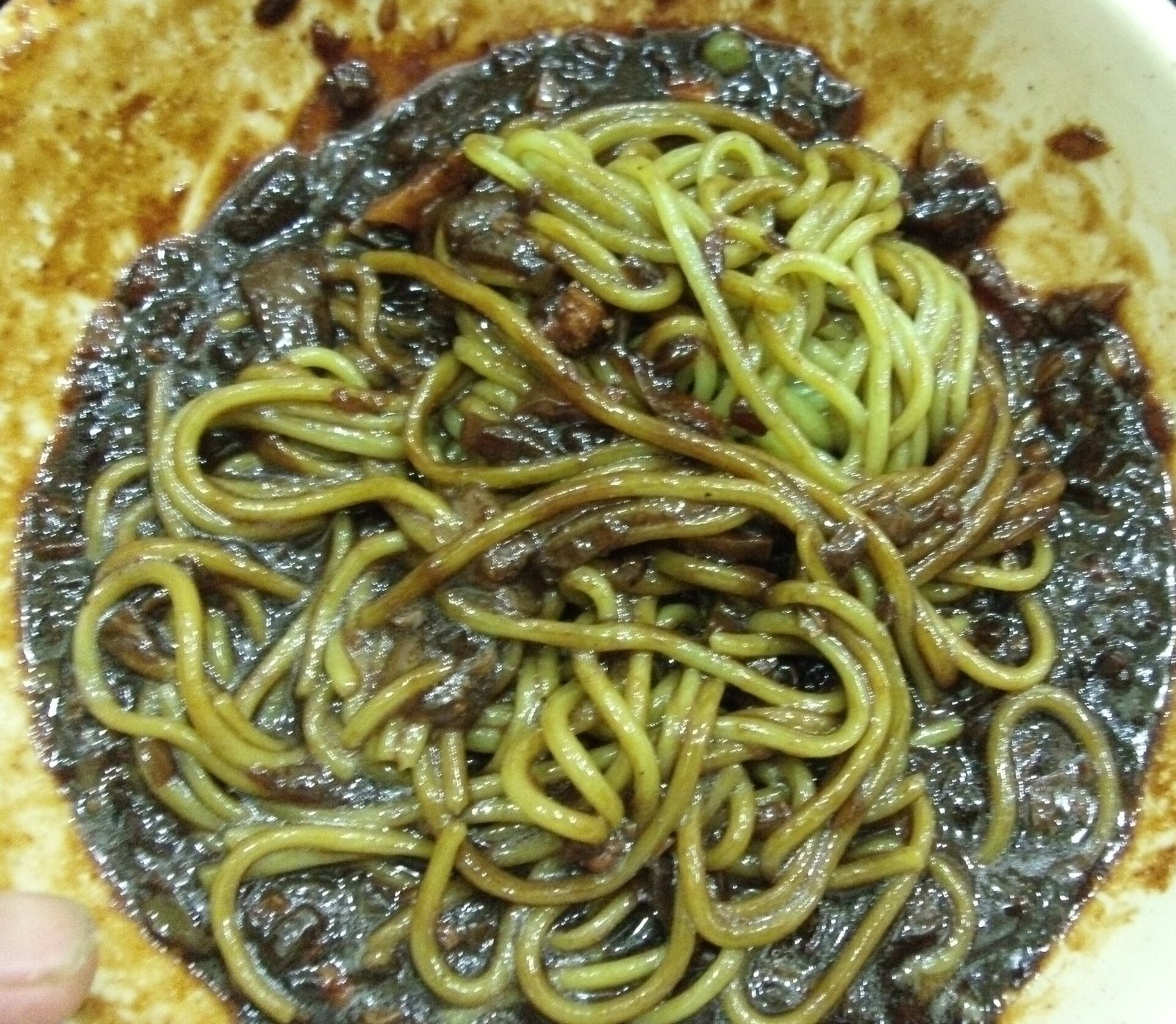 broccoli pesto green spaghetti in a rustic bowl with lemon wedges