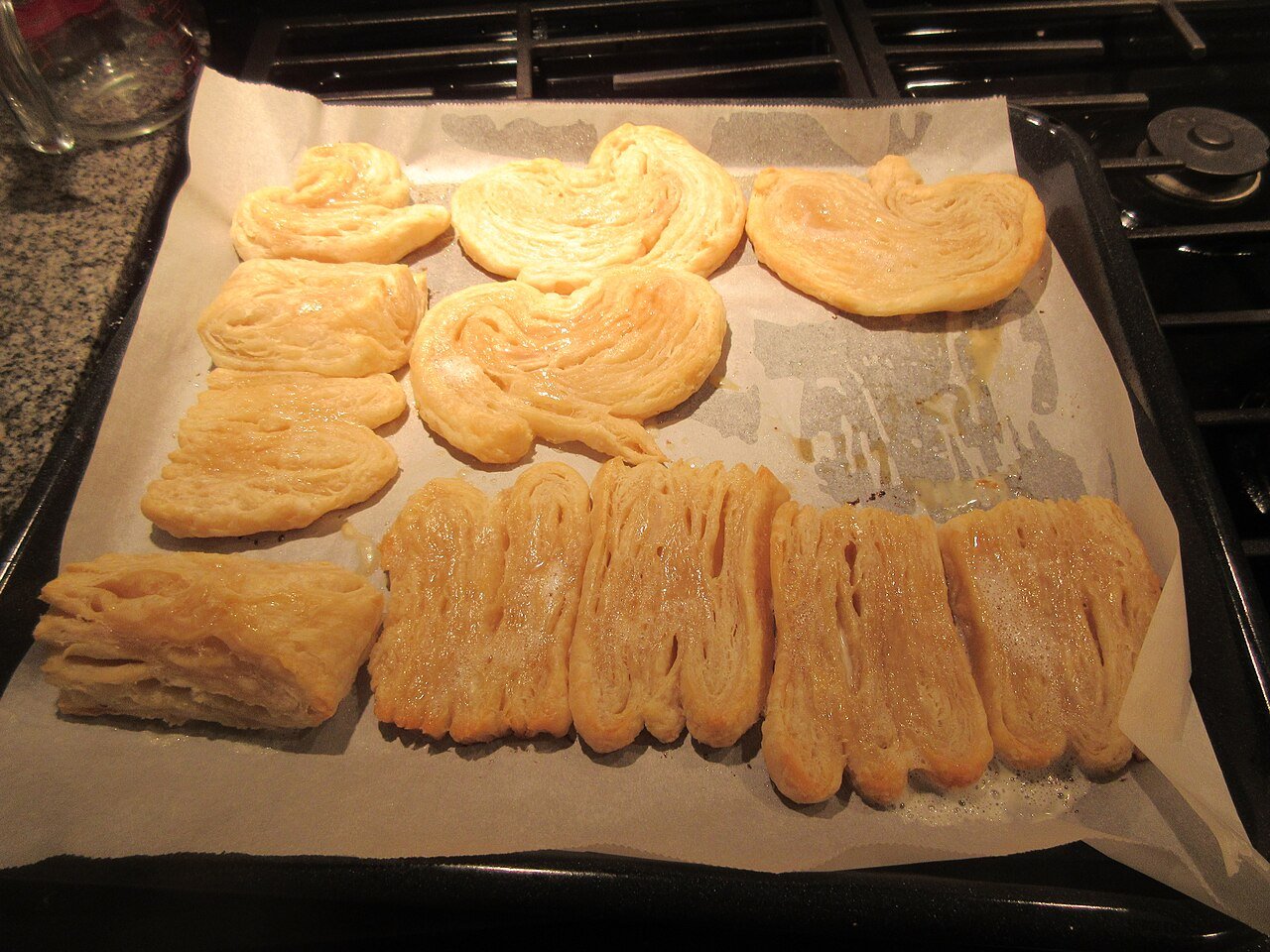 Pastry bites arranged on a tray, ready for the oven