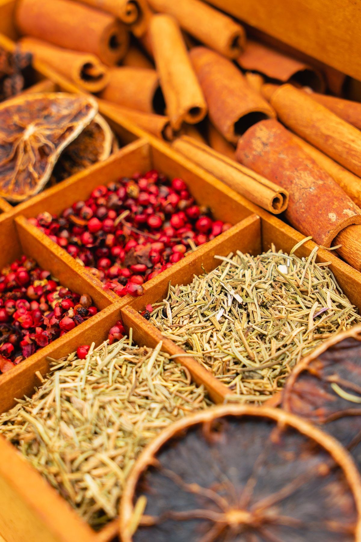 Assorted homemade spice blends in labeled glass jars on a wooden kitchen counter