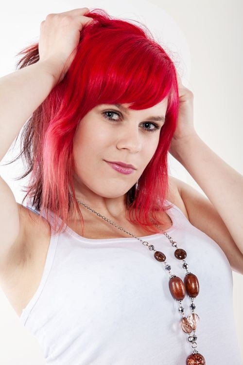 Hair with deep teal roots fading into soft pink ends