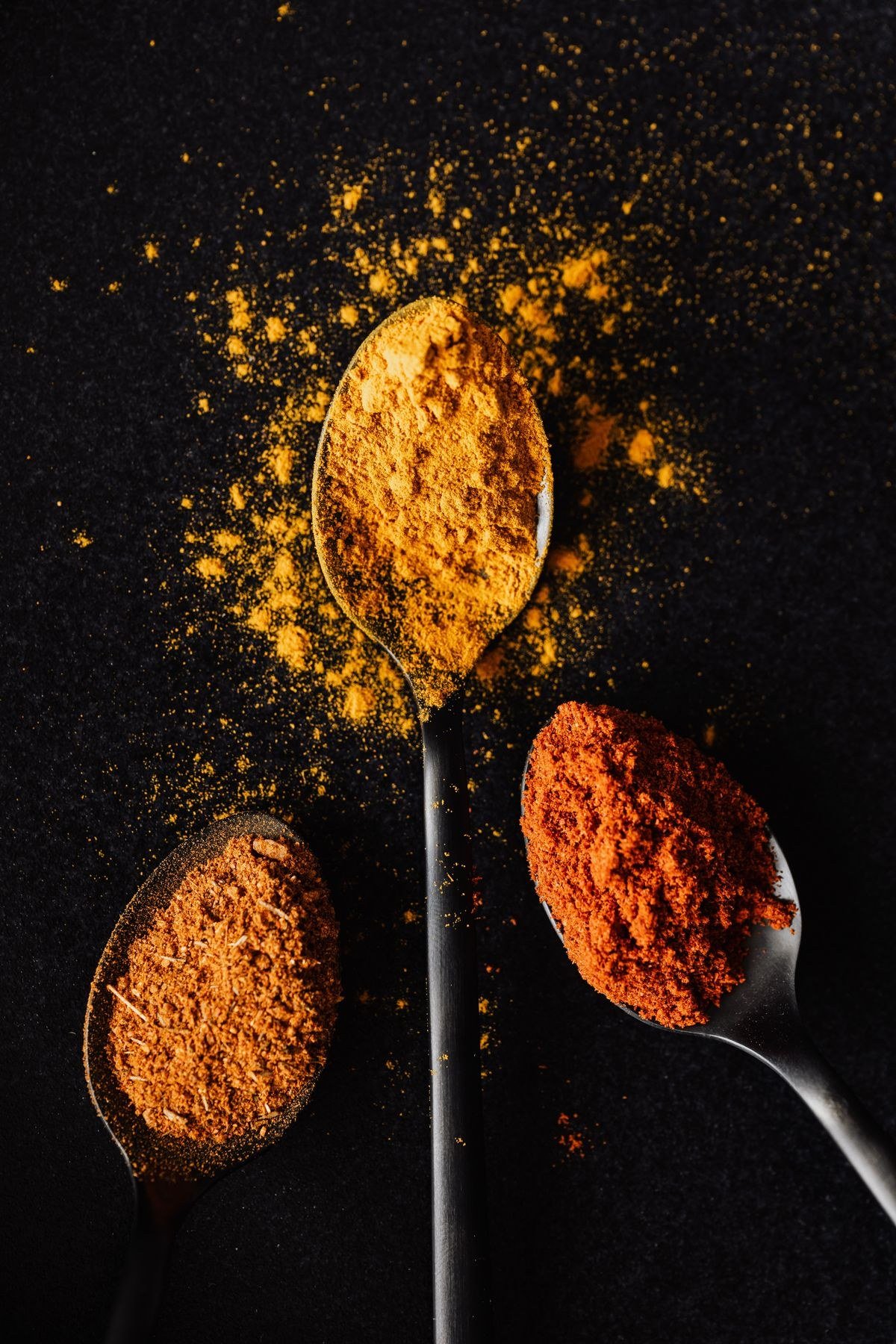 Freshly ground spice blend being sifted through a fine mesh sieve