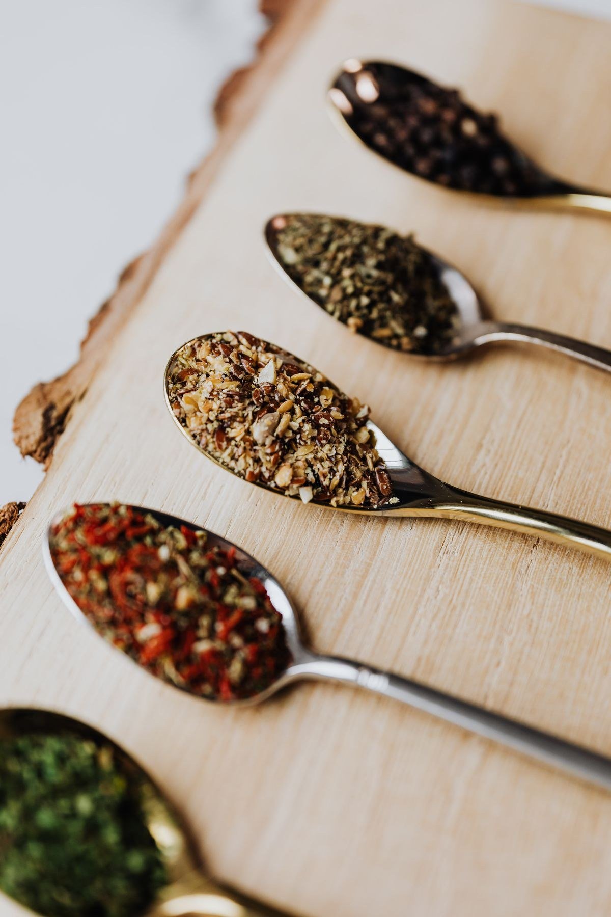 Homemade taco seasoning blend in a small bowl with chili peppers