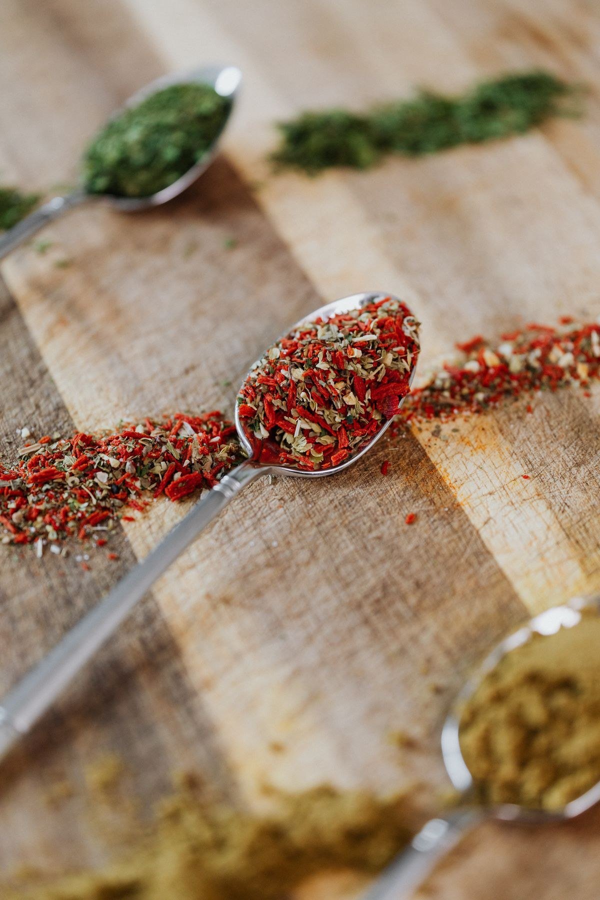 Barbecue dry rub spices in a bowl beside grilled ribs