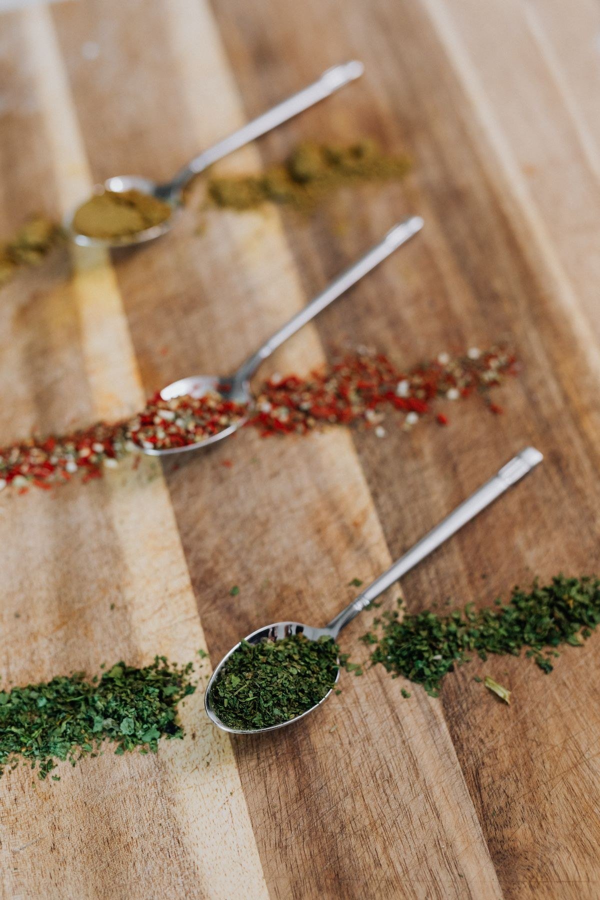 Homemade garam masala in a brass bowl with cinnamon and cardamom