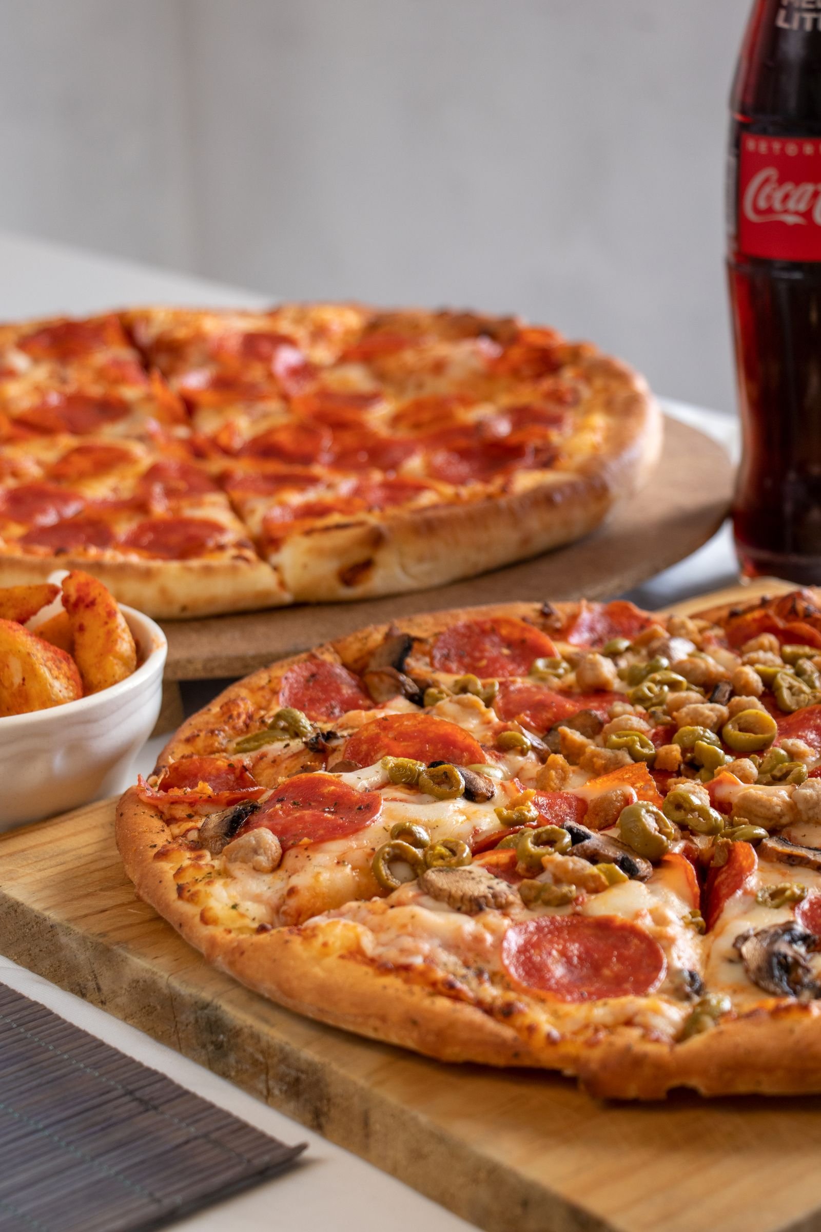 Freshly baked pizza with golden melted cheese on a wooden board