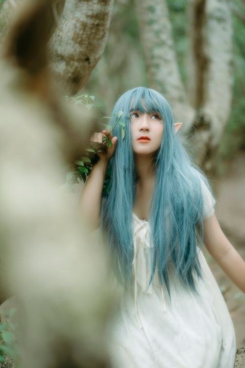Teal and pink hair with a dark shadow root for easy grow-out