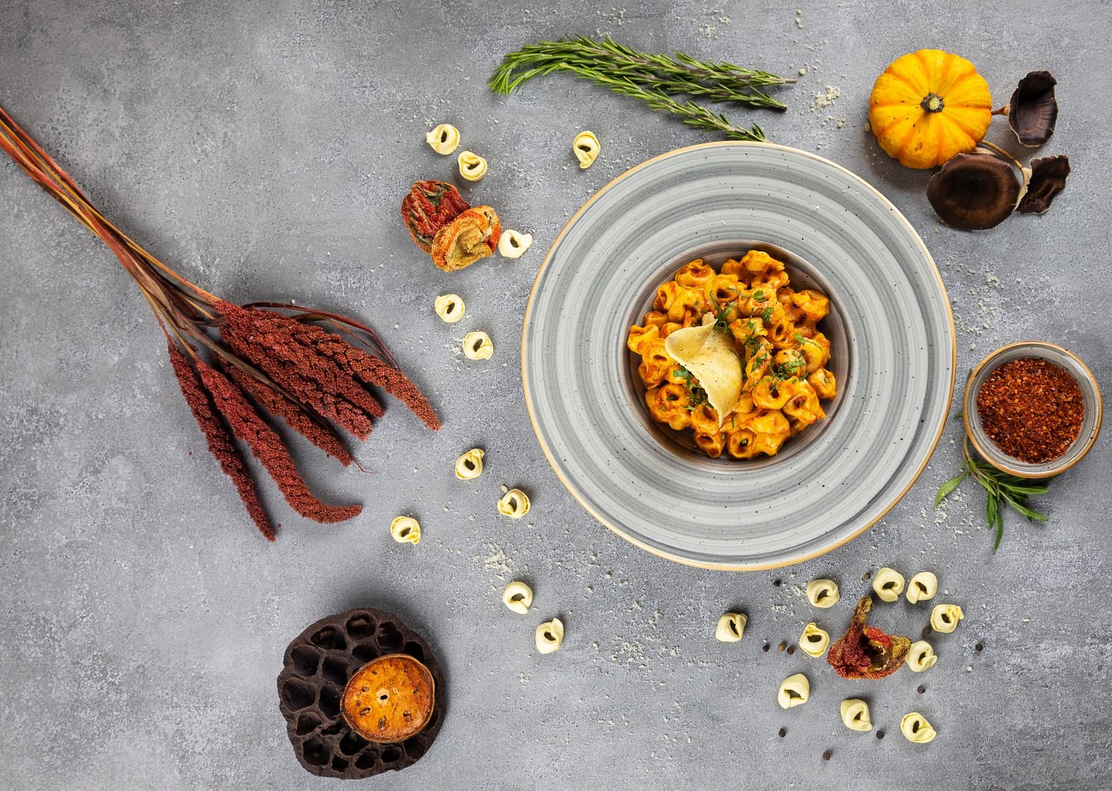 Gourmet pumpkin tortellini served with herbs on a rustic wooden table