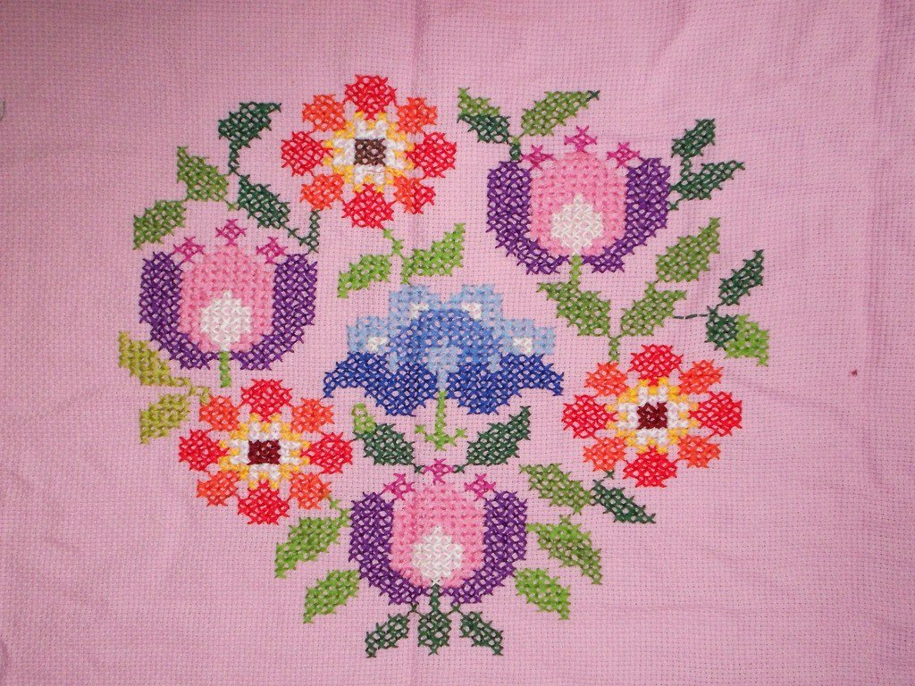Close-up of neat even cross stitches in autumn colours