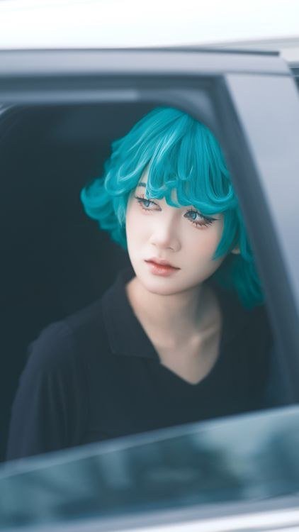 Split dye teal and pink hair with a matching fringe