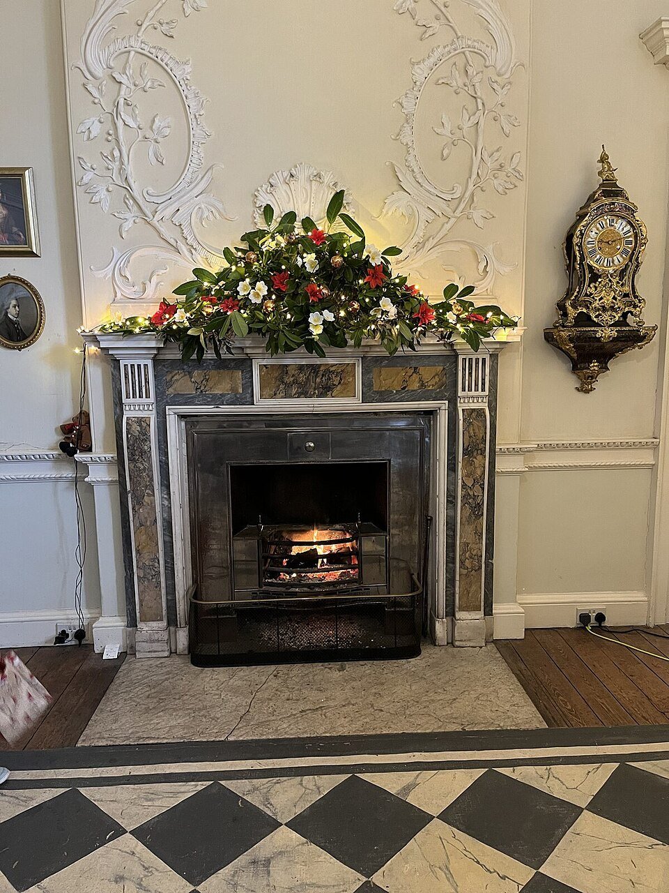 A finished mantle garland glowing with lights and decorations