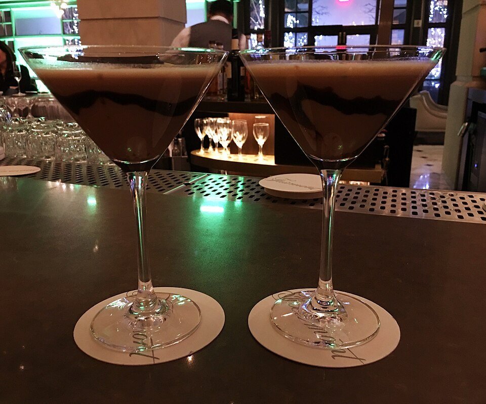 A peppermint martini with a candy cane rim and garnish
