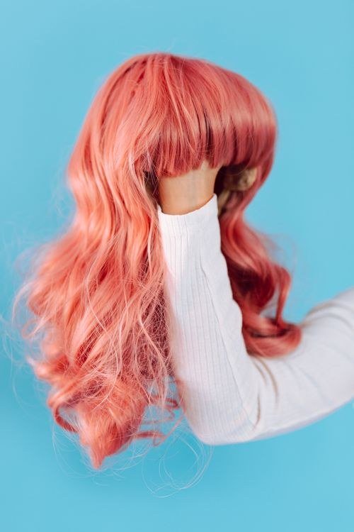 Pink wig with dark roots for a natural grown-out look
