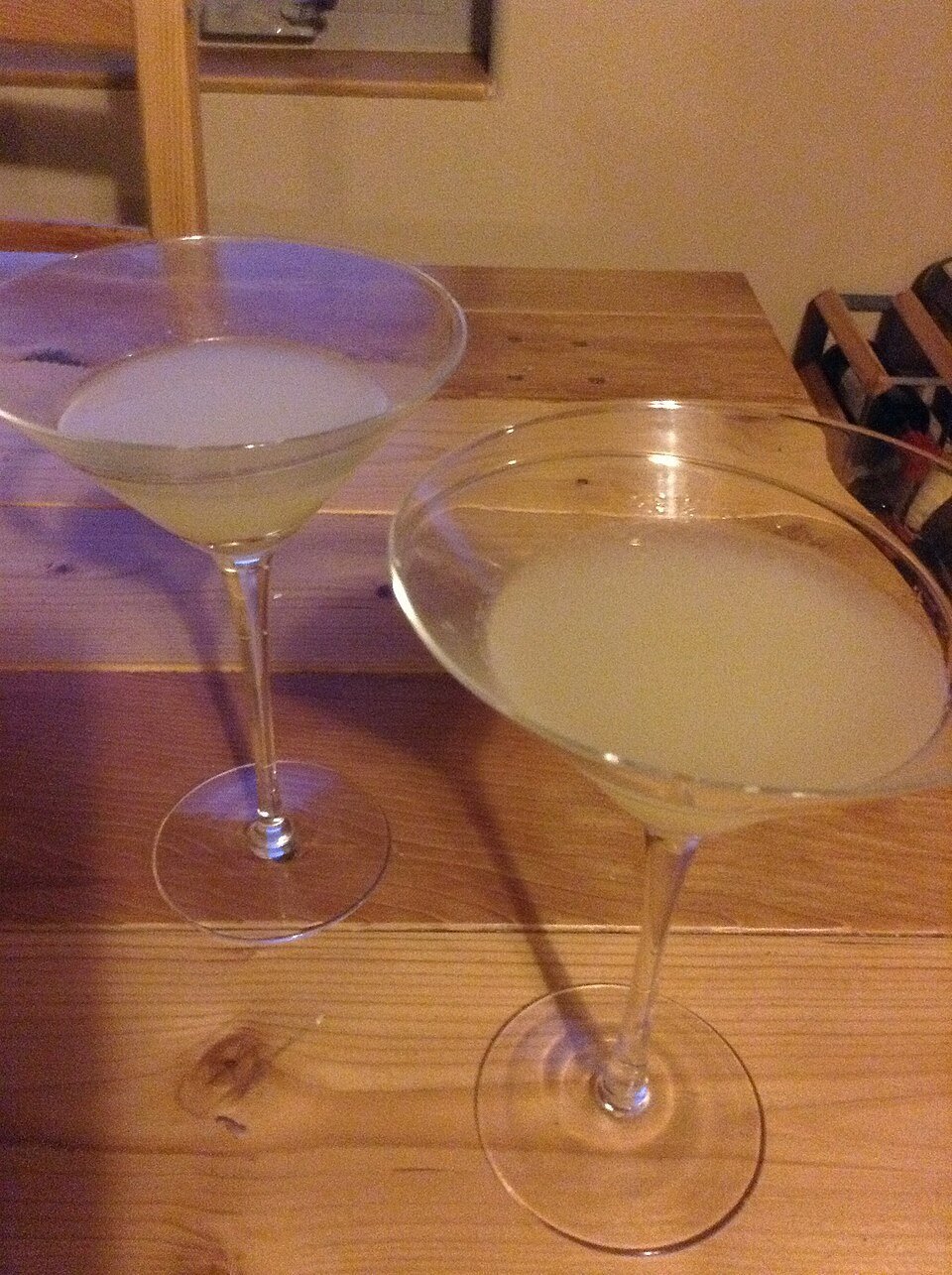 A martini served beside Christmas appetizers on a festive table