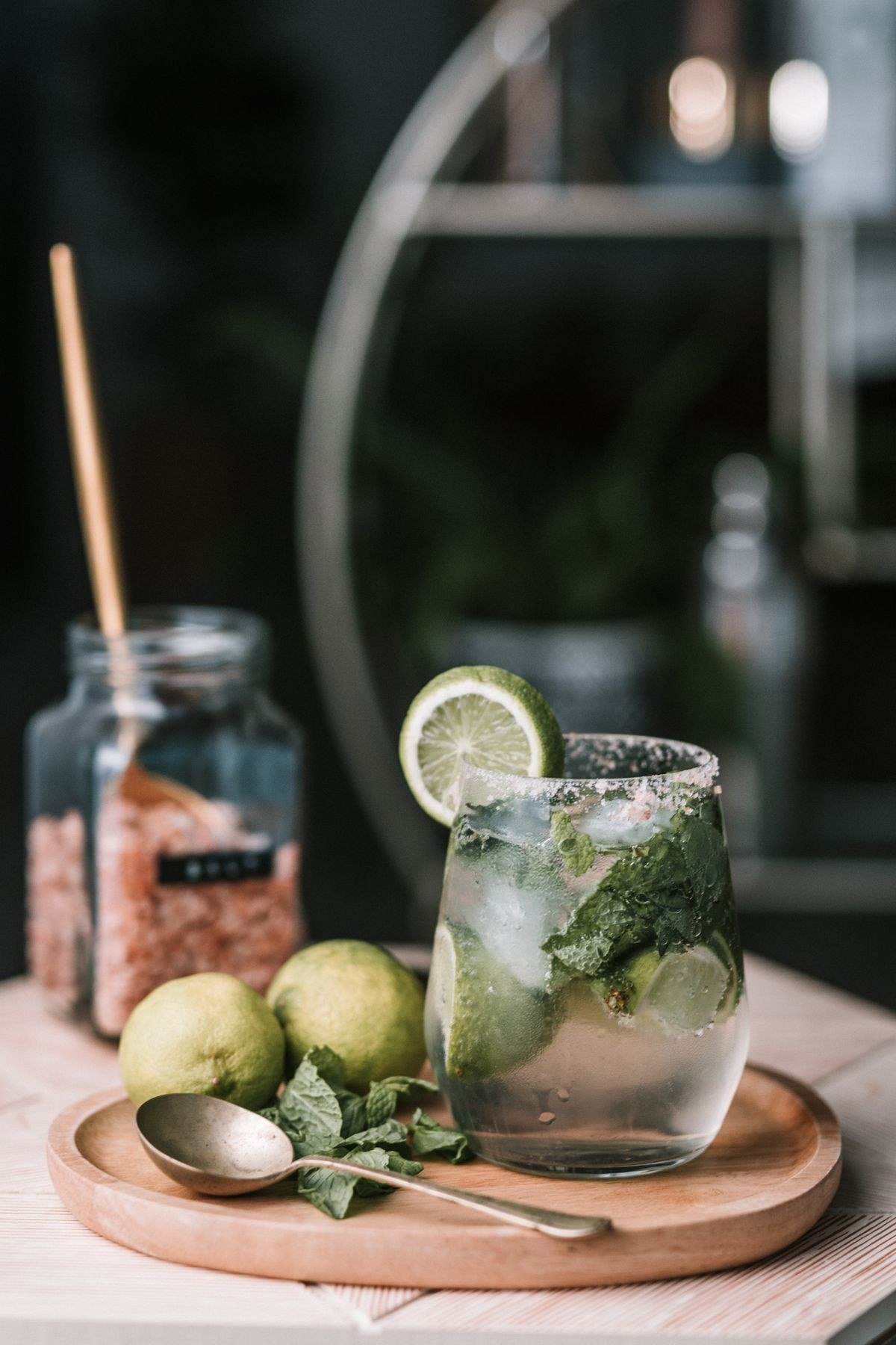 Responsible cocktail serving with water and snacks at a home bar
