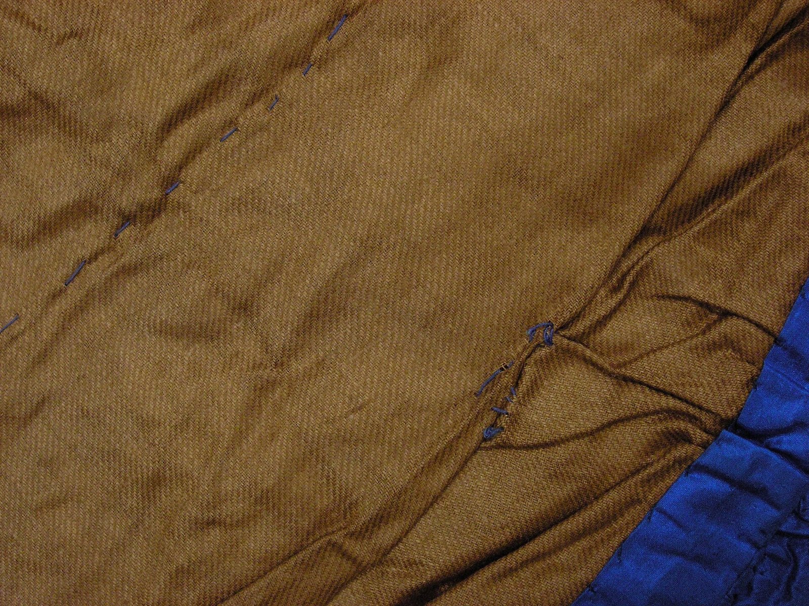 chocolate brown wool coat over cream sweater and jeans