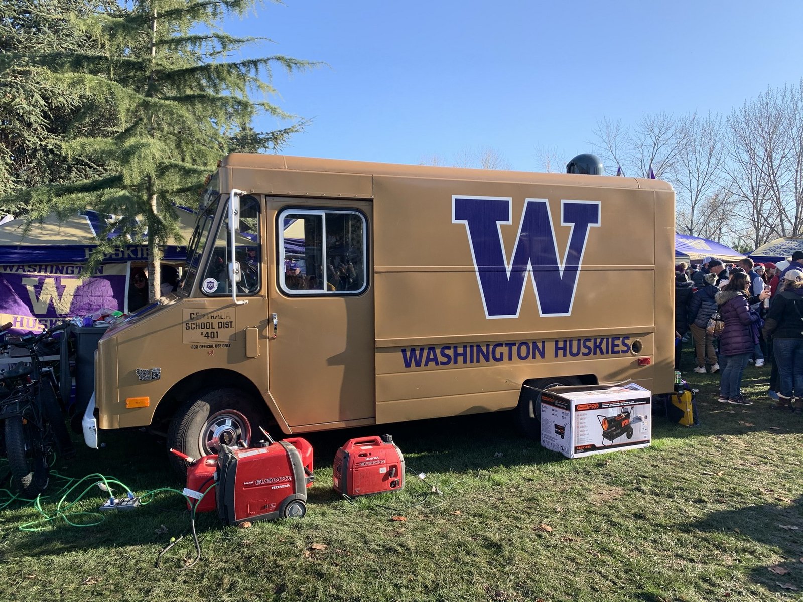 Burgers and sausages grilling at a fall tailgate party