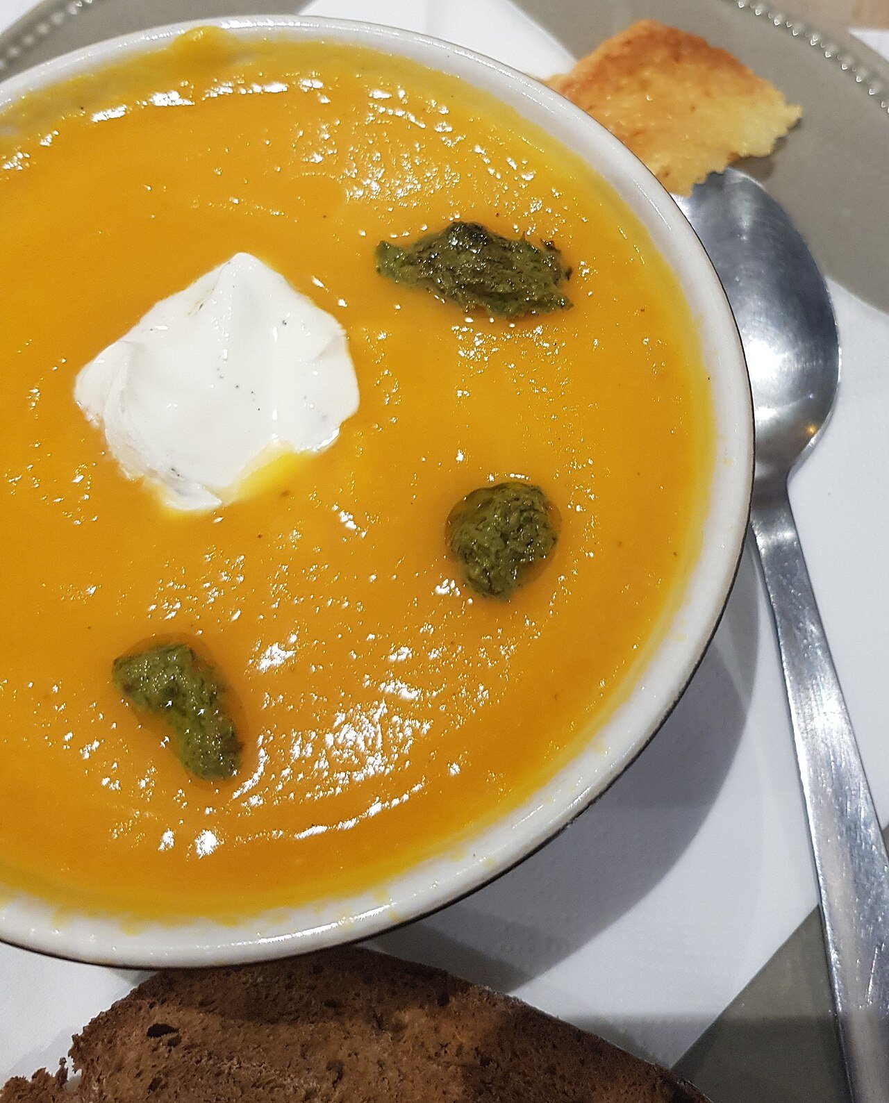 Vegan pumpkin soup with coconut cream cobweb