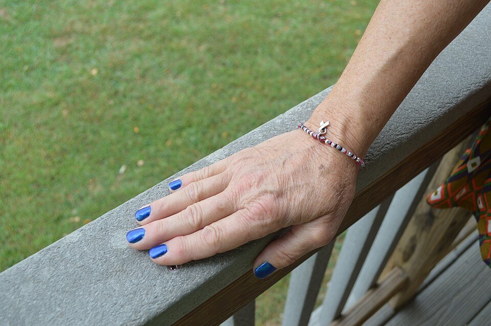 Matte blue nails beside glossy gold nails for comparison