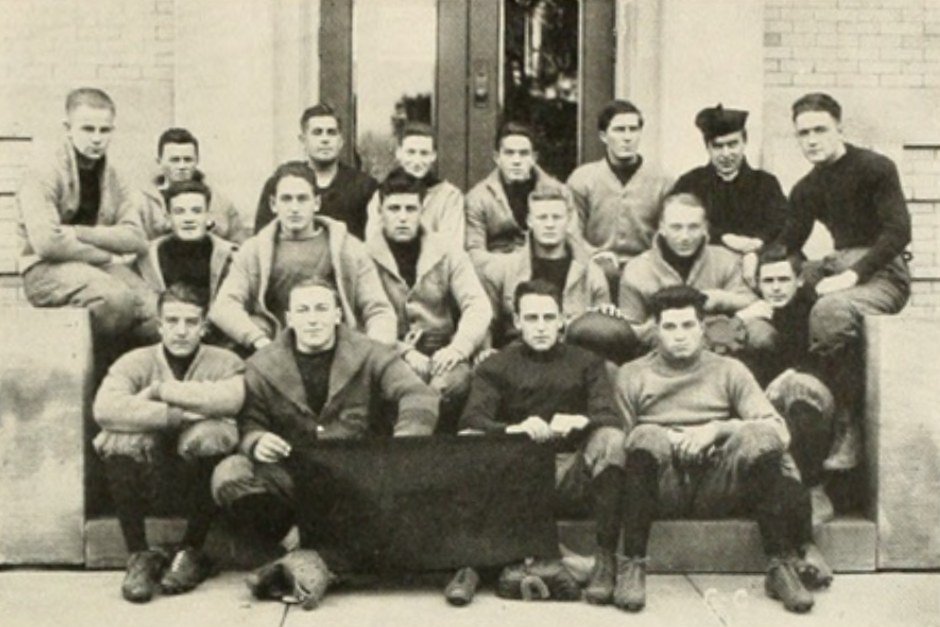 Tailgaters dressed in warm layers and team gear for a fall game