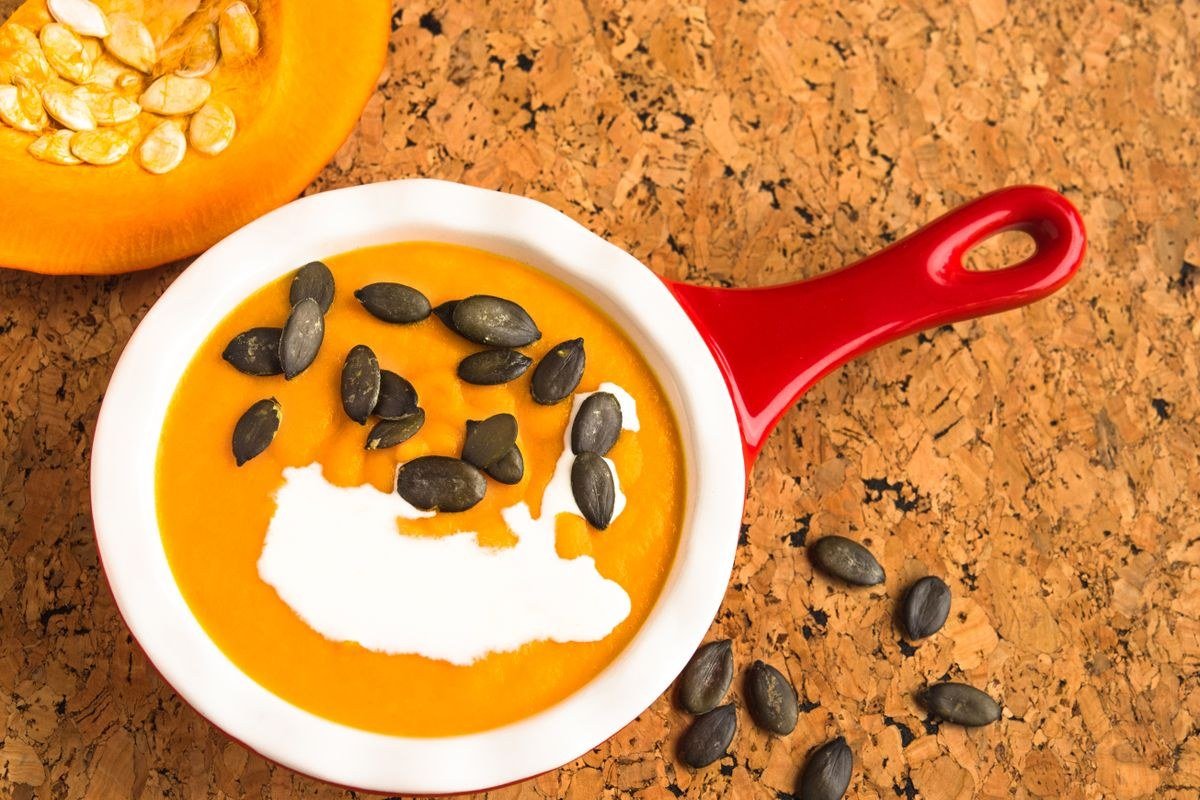 Halloween table setting with pumpkin soup centrepiece