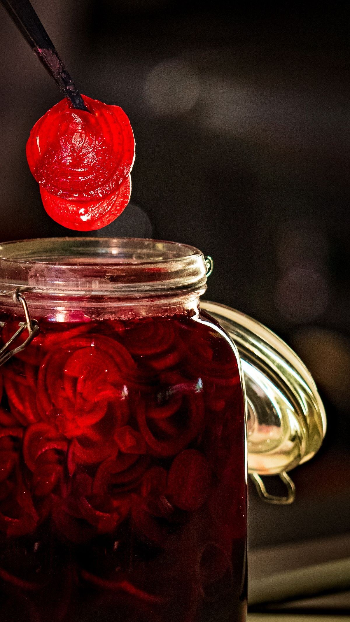 Jars of home-canned pickled beets with deep ruby red color on a pantry shelf