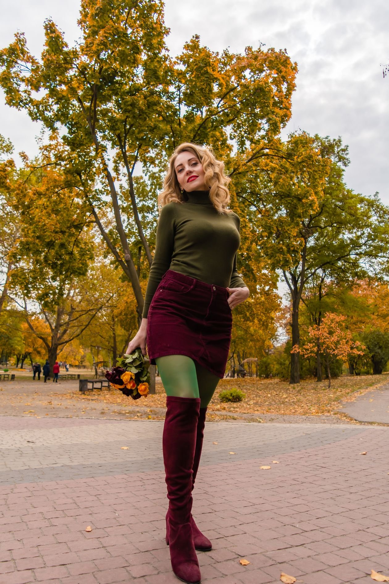 burgundy knee high boots with black mini skirt and sweater