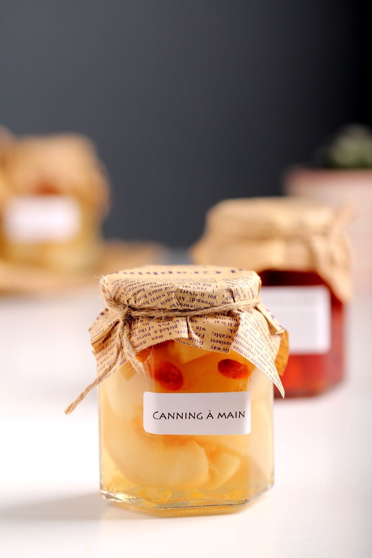 Sliced pickled beets packed into mason jars with hot vinegar brine